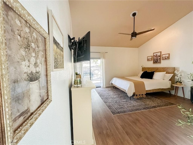 bedroom with a ceiling fan, lofted ceiling, and wood finished floors