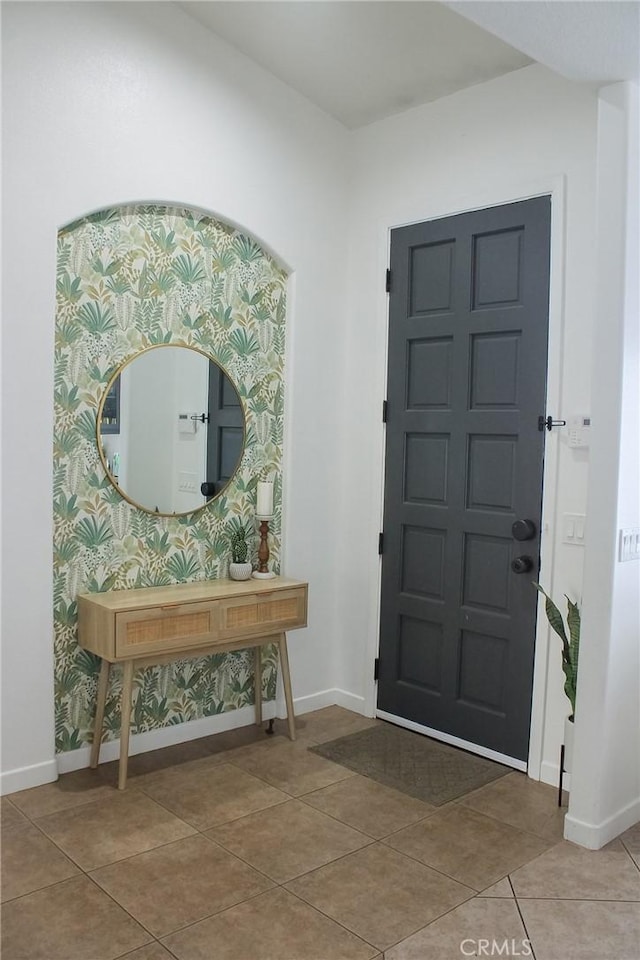 entrance foyer with baseboards and tile patterned flooring