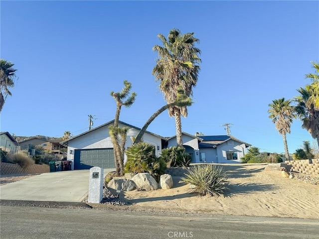 view of front of home with an attached garage and concrete driveway