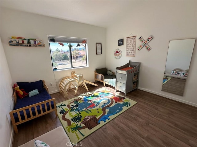 recreation room with baseboards and wood finished floors