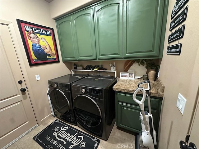 washroom featuring light tile patterned floors, cabinet space, and independent washer and dryer