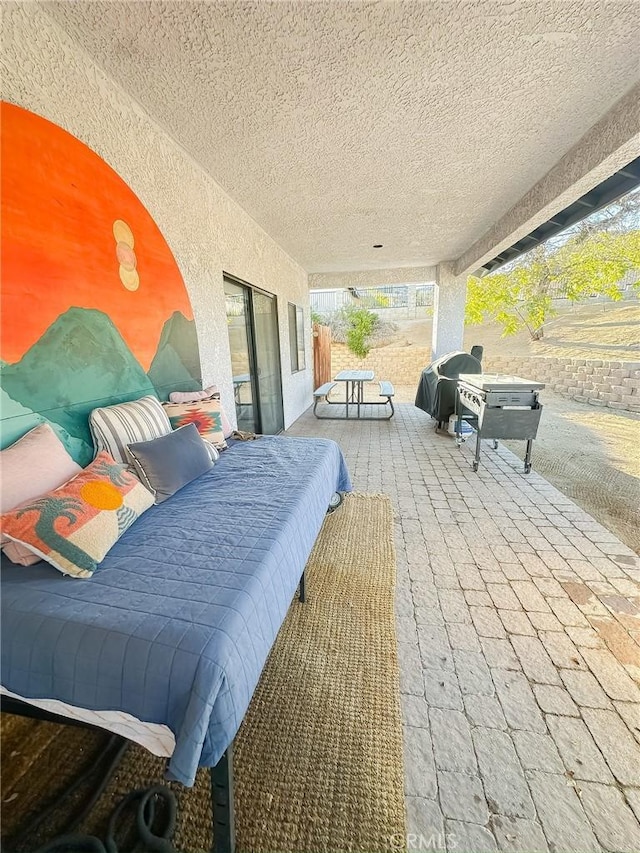 bedroom featuring a textured ceiling and access to exterior