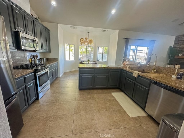 kitchen with visible vents, a healthy amount of sunlight, decorative backsplash, stainless steel appliances, and a sink