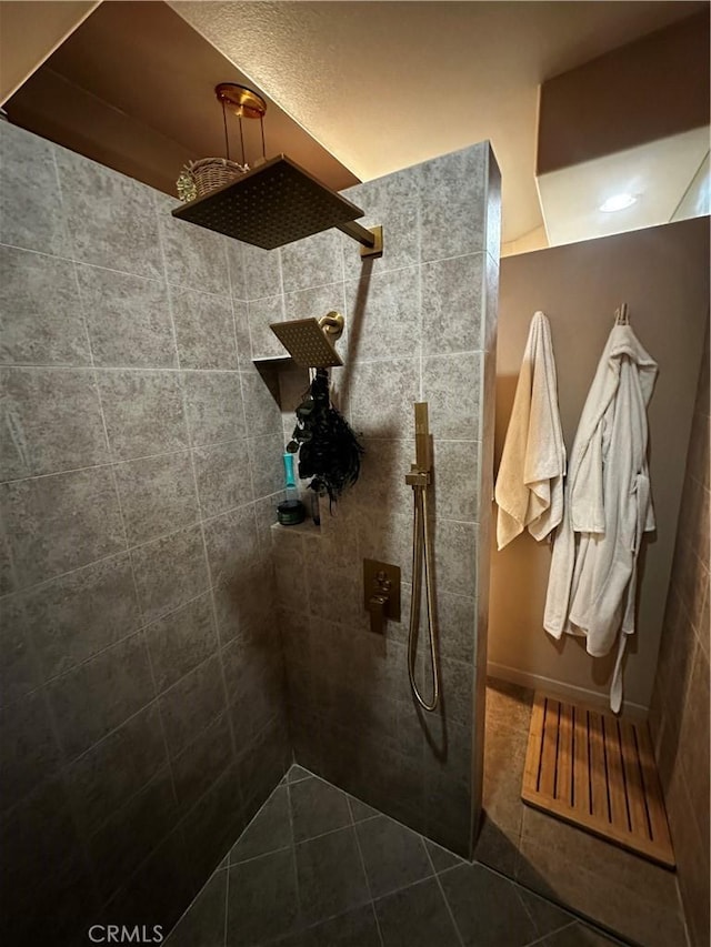 bathroom featuring walk in shower and tile patterned flooring