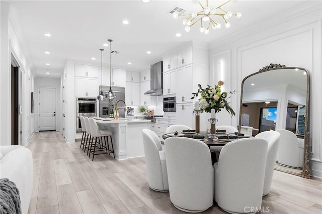 450 Chorus, Irvine, CA 92618 - dining room with light wood-style floors, a notable chandelier, and ornamental molding