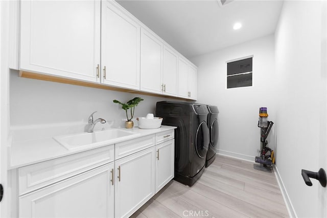 450 Chorus, Irvine, CA 92618 - laundry area with a sink, washer and dryer, cabinet space, light wood finished floors, and baseboards