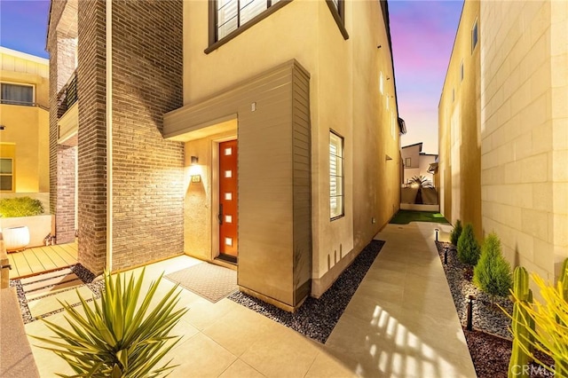 450 Chorus, Irvine, CA 92618 - exterior entry at dusk with visible vents and stucco siding