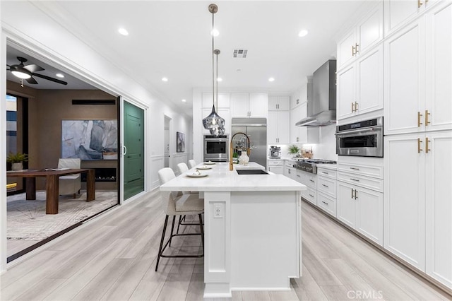 450 Chorus, Irvine, CA 92618 - kitchen with stainless steel appliances, visible vents, wall chimney exhaust hood, and white cabinetry