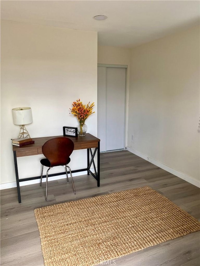 office featuring baseboards and wood finished floors