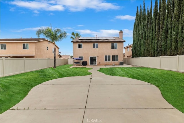 29193 Via Espada, Murrieta, CA 92563 - back of house featuring a patio, roof mounted solar panels, stucco siding, and a chimney