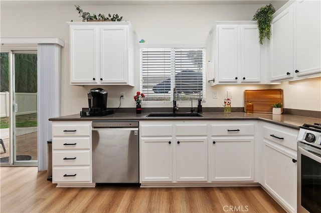 29193 Via Espada, Murrieta, CA 92563 - kitchen featuring appliances with stainless steel finishes, a sink, light wood-style flooring, and white cabinetry