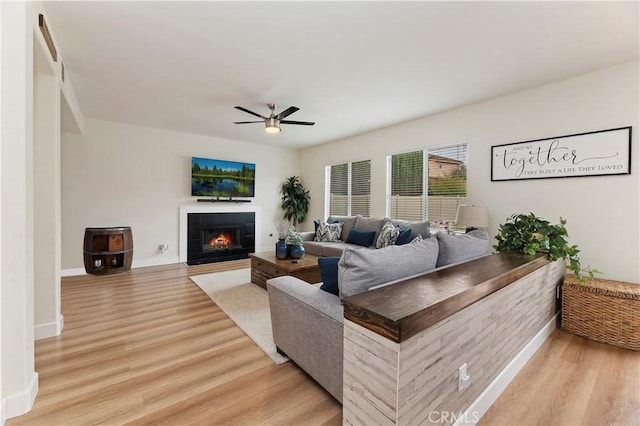 29193 Via Espada, Murrieta, CA 92563 - living room with ceiling fan, light wood finished floors, a tile fireplace, and baseboards