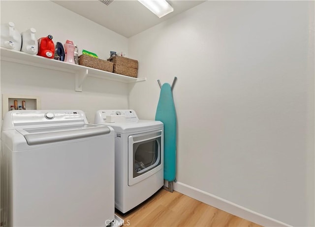 29193 Via Espada, Murrieta, CA 92563 - laundry room with washing machine and clothes dryer, light wood-style flooring, and baseboards