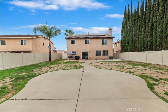 29193 Via Espada, Murrieta, CA 92563 - back of house with a patio, a fenced backyard, roof mounted solar panels, and stucco siding