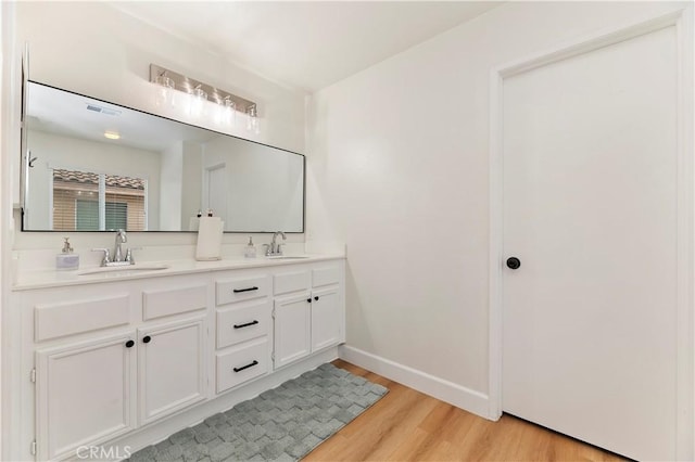 29193 Via Espada, Murrieta, CA 92563 - bathroom featuring wood finished floors, double vanity, and baseboards