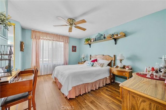 bedroom featuring a ceiling fan and wood finished floors