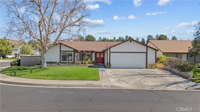 single story home featuring a front yard, an attached garage, and driveway