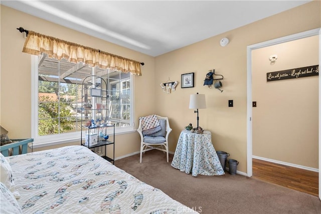 bedroom with baseboards and carpet floors