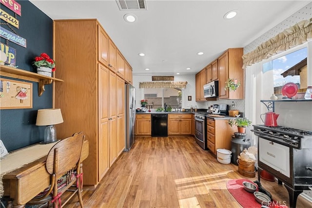 kitchen featuring recessed lighting, visible vents, light wood-style flooring, and appliances with stainless steel finishes