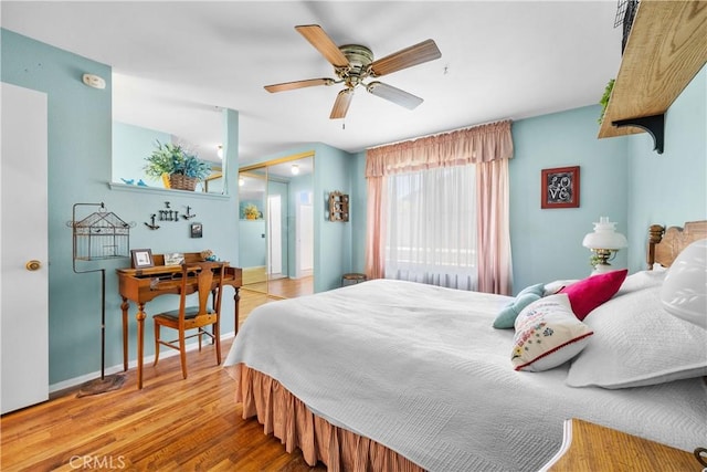 bedroom featuring a ceiling fan, wood finished floors, and baseboards