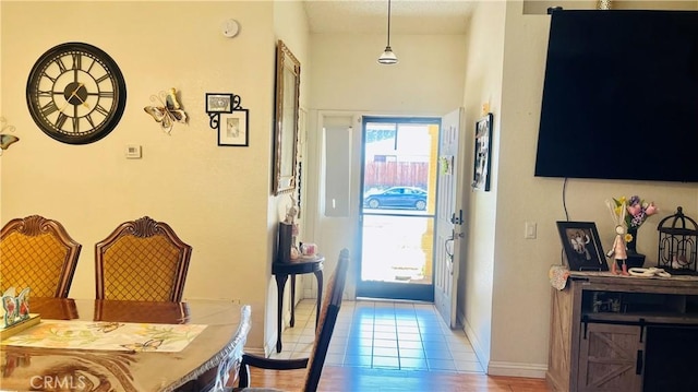 entryway with light tile patterned floors and baseboards