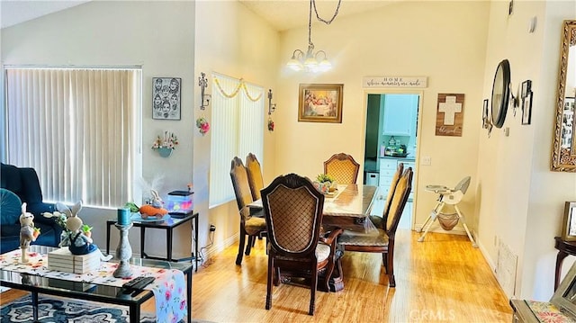 dining space featuring a notable chandelier, visible vents, light wood-type flooring, and baseboards