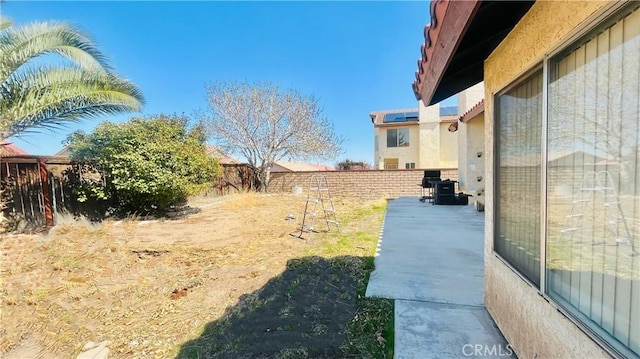 view of yard with a patio and a fenced backyard