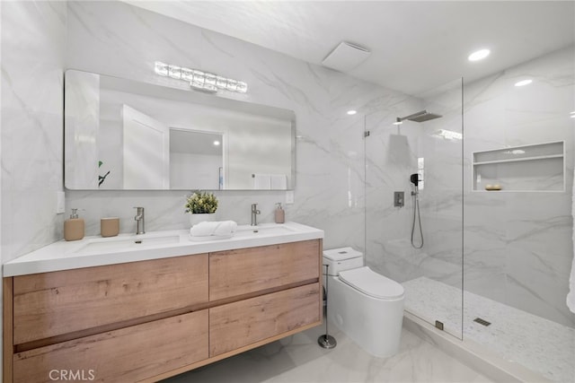 full bath featuring a sink, a marble finish shower, and marble finish floor