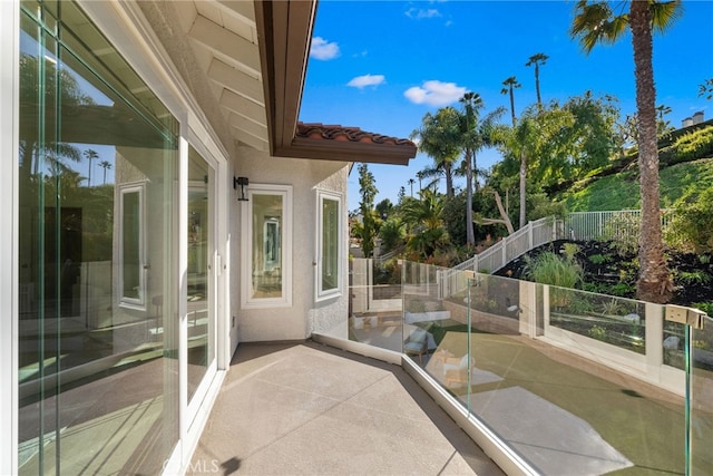 view of patio / terrace featuring a balcony and fence