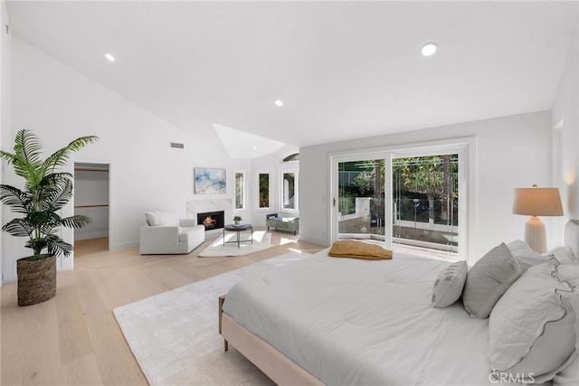 bedroom featuring visible vents, recessed lighting, a fireplace, and light wood-style floors