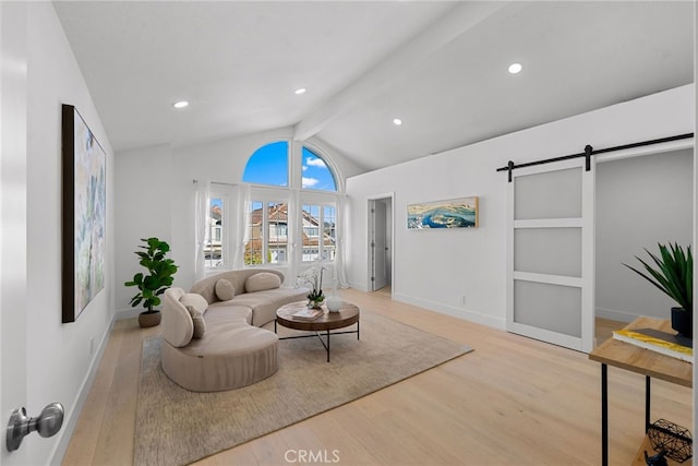 living room with baseboards, vaulted ceiling with beams, a barn door, and wood finished floors