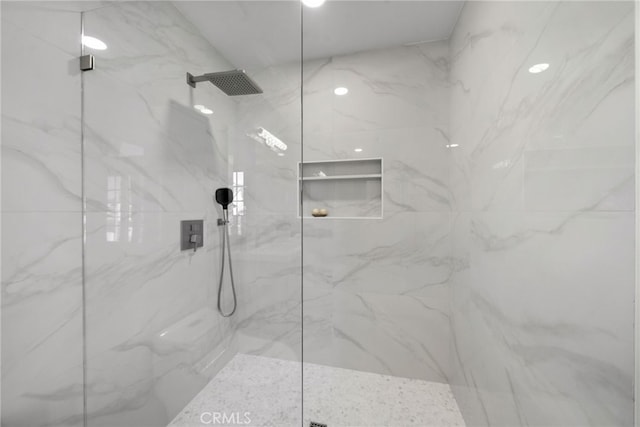 full bathroom featuring a marble finish shower