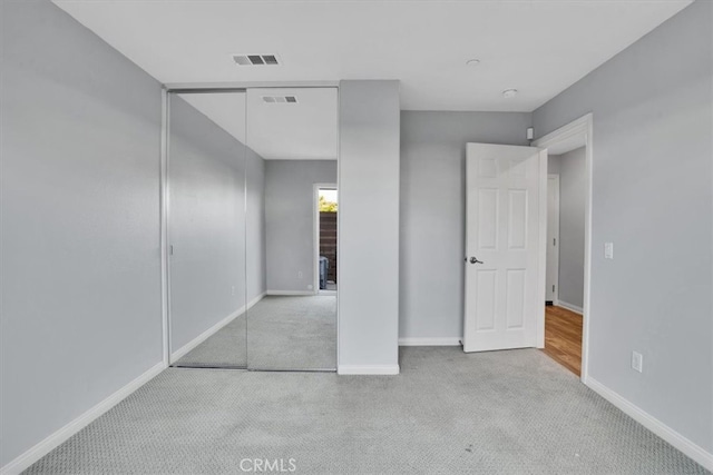 unfurnished bedroom with visible vents, baseboards, and carpet