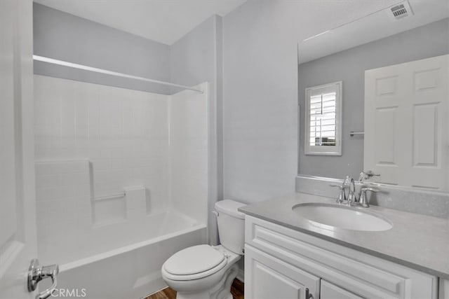 full bath with visible vents, toilet, vanity, and shower / tub combination