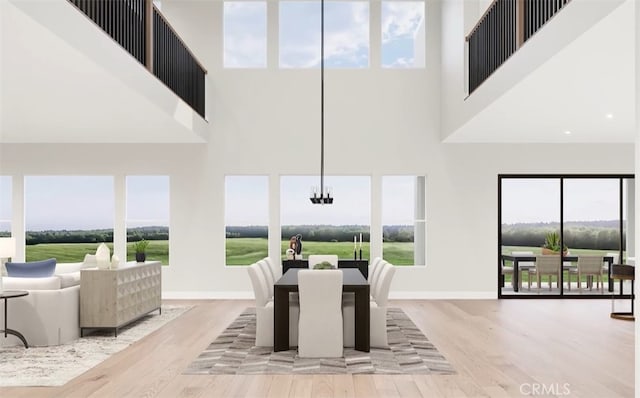 9547 N Andora Ave, Chatsworth, CA 91311 - dining room featuring a towering ceiling, baseboards, a chandelier, and wood finished floors