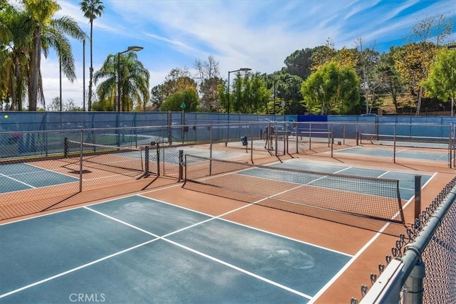 view of sport court featuring fence