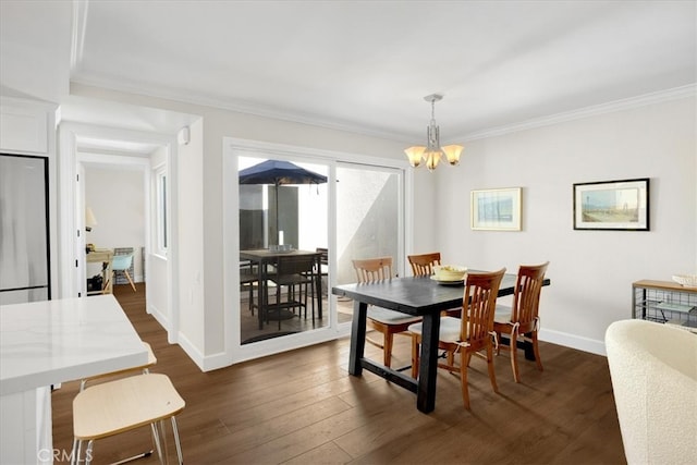 dining room featuring a chandelier, baseboards, dark wood finished floors, and crown molding