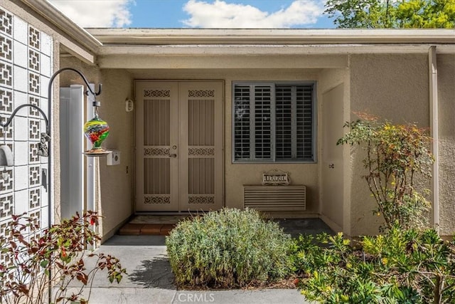 entrance to property featuring stucco siding