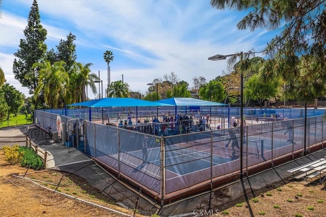 view of tennis court with fence