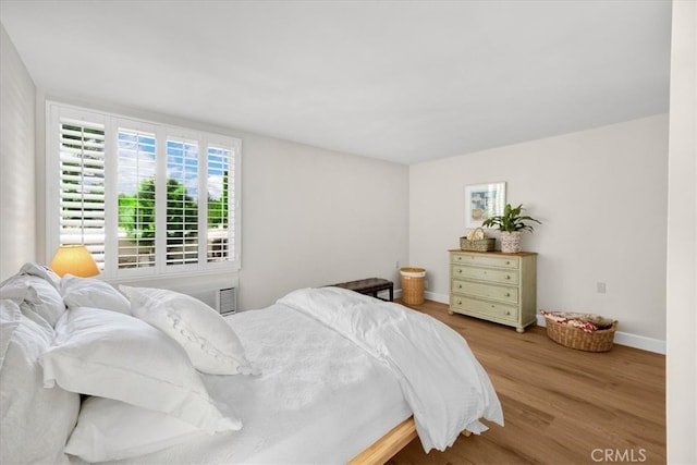 bedroom with wood finished floors and baseboards