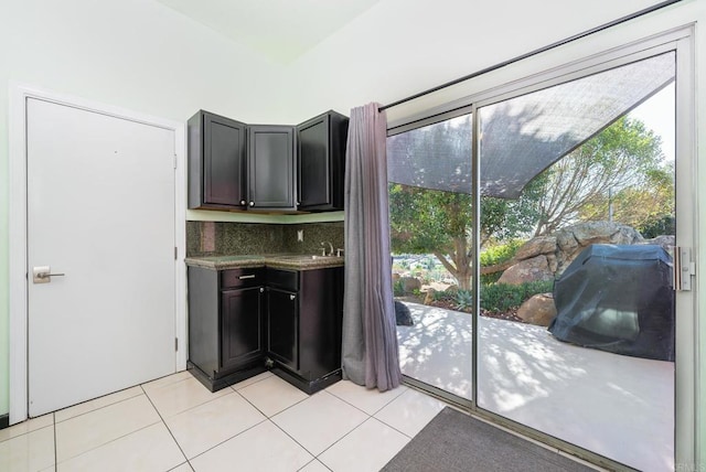 interior space with light tile patterned floors, decorative backsplash, and plenty of natural light