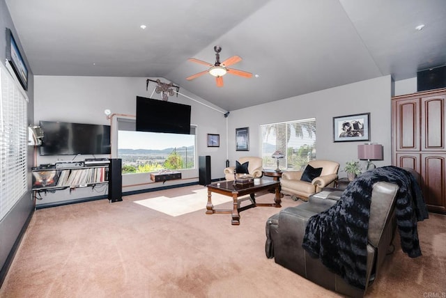 living area featuring carpet, ceiling fan, and vaulted ceiling