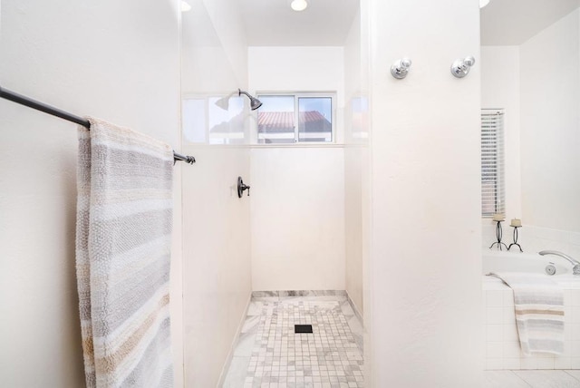 bathroom with a shower and a bath