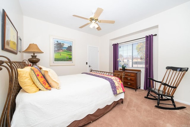 bedroom featuring light carpet and a ceiling fan