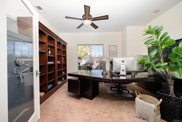 office with visible vents, a ceiling fan, and carpet flooring