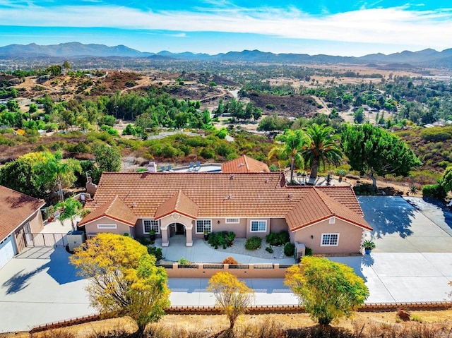 birds eye view of property with a mountain view