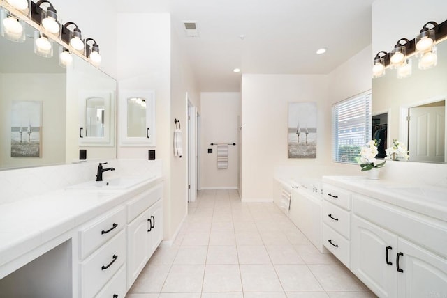 bathroom with vanity, visible vents, recessed lighting, tile patterned flooring, and a bath