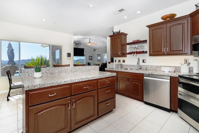 1185 Cedar Summit Dr, Ramona, CA 92065 - kitchen with appliances with stainless steel finishes, healthy amount of natural light, light tile patterned floors, lofted ceiling, and recessed lighting