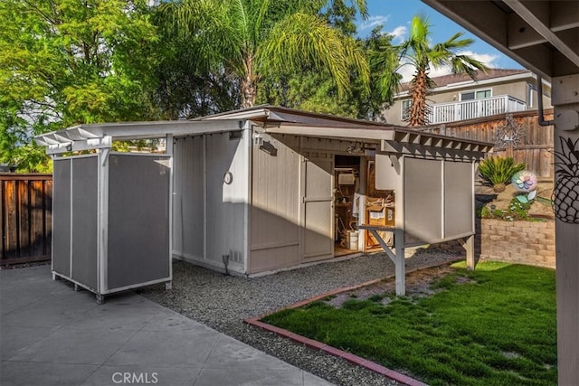 view of outbuilding with an outdoor structure and fence