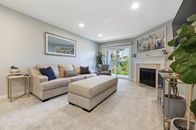 living room with a fireplace, recessed lighting, light colored carpet, and baseboards